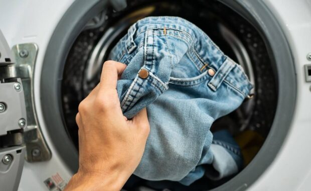 putting Jeans into the washing machine