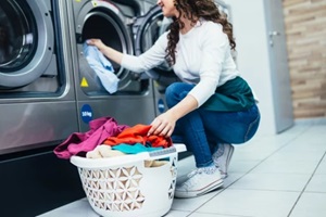 female employee working at laundromat shop